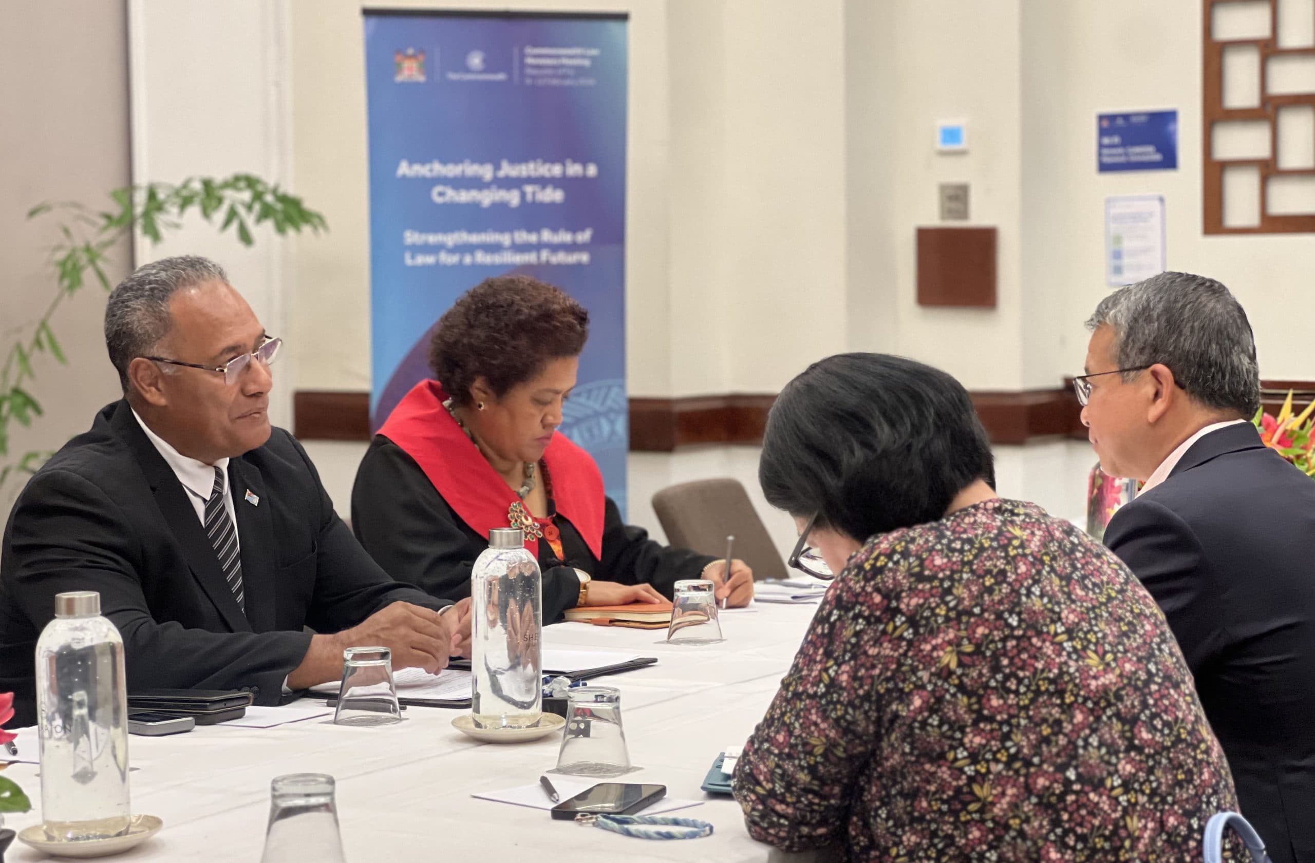 Officials and delegates meeting around a table