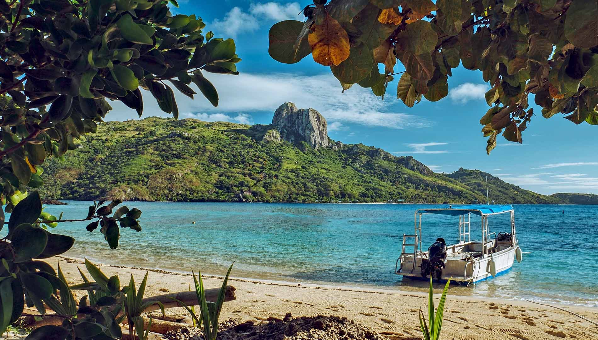 A boat moored at a scenic Fiji beach